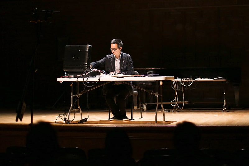A musician performs an electronic composition as part of the Songlines concert series hosted by Mills Performing Arts