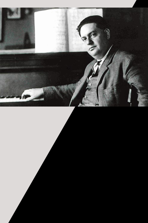 A black and white photograph of Darius Milhaud, dressed in a three piuece suit, seated at a piano, gently slouched, with their hand placed on the keyboard. 